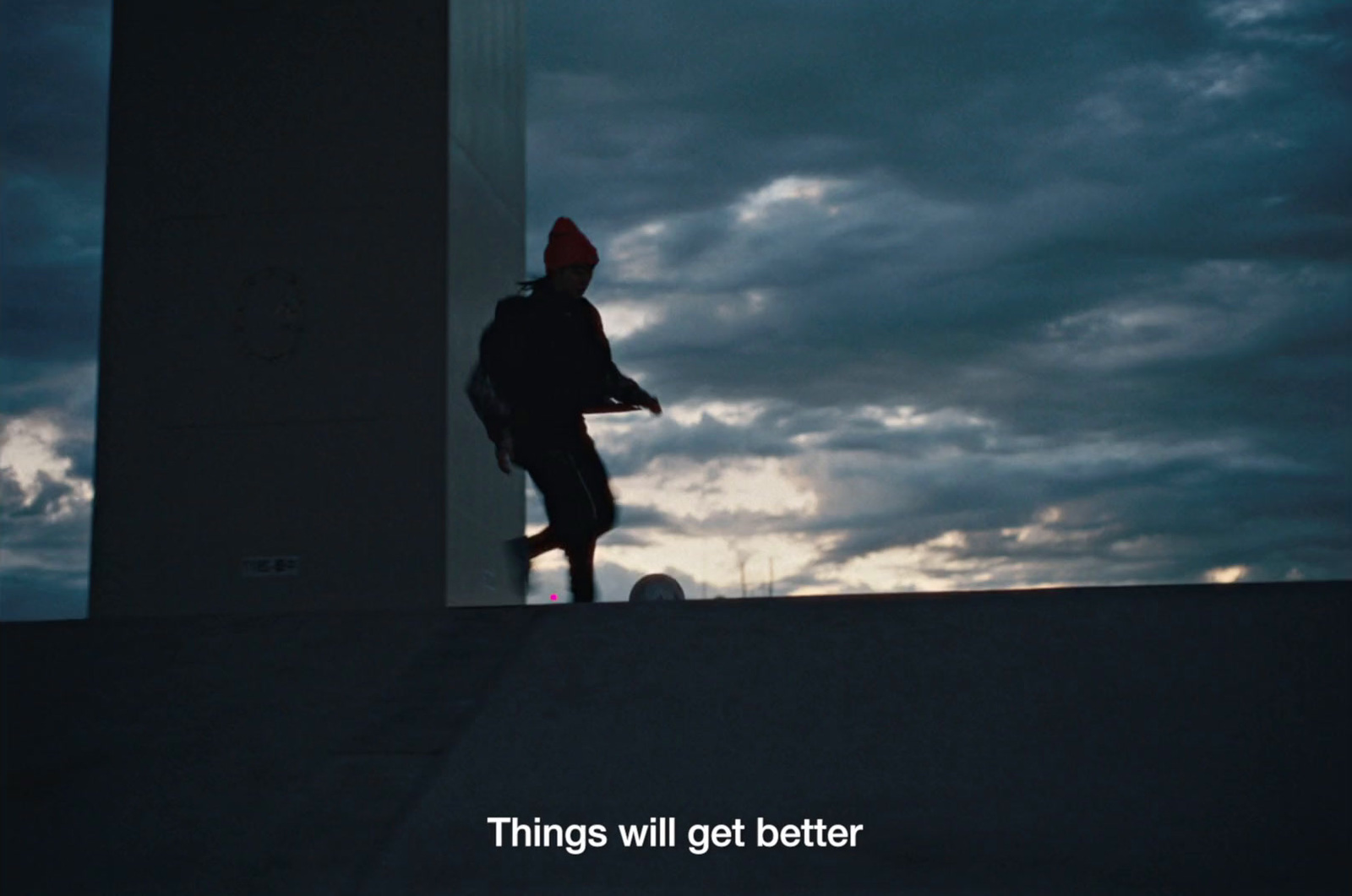 a person walking up a ramp with a sky in the background