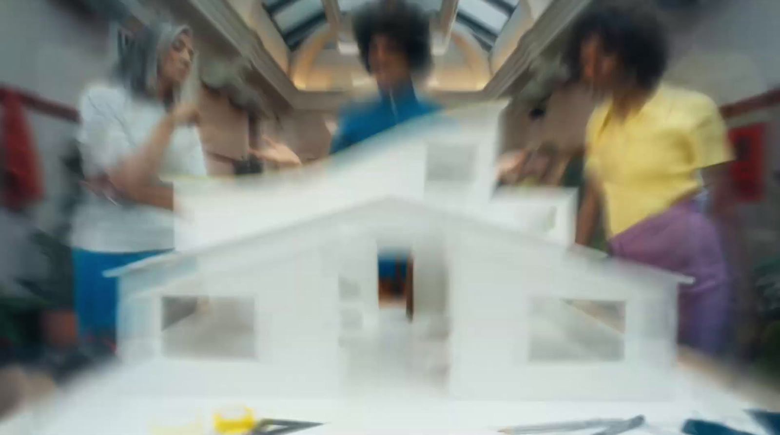 a blurry photo of a group of people inside a house