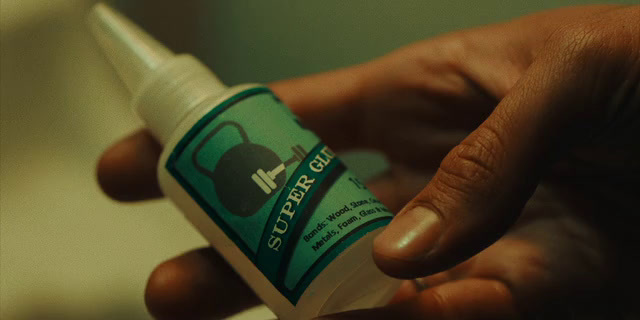 a person holding a bottle of mouthwash in their hand