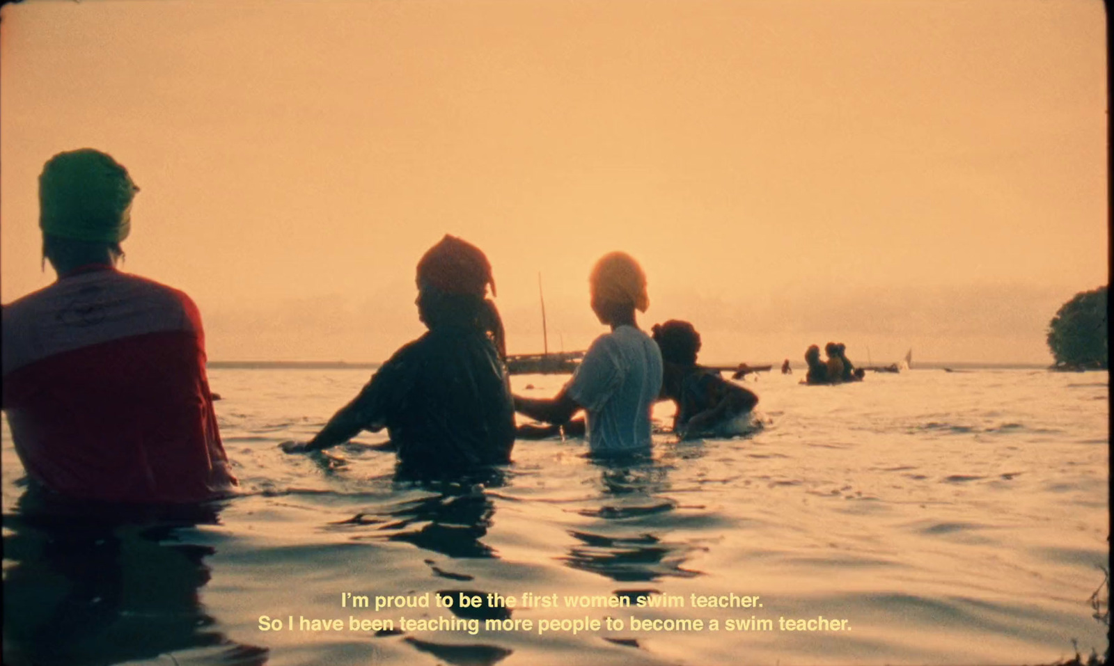 a group of people sitting in a body of water