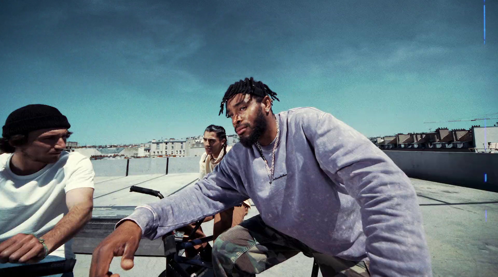 a man riding a bike next to another man on a skateboard