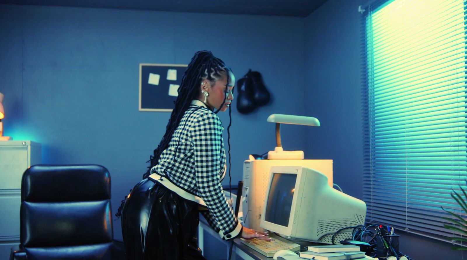 a woman standing in front of a computer monitor