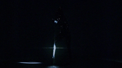 a person standing in the dark with a flashlight