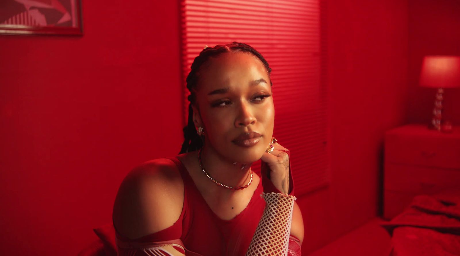 a woman in a red room talking on a cell phone