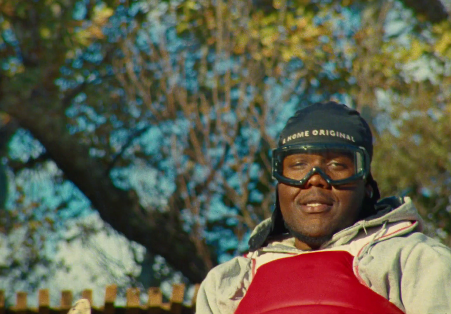 a man in a hat and goggles holding a frisbee