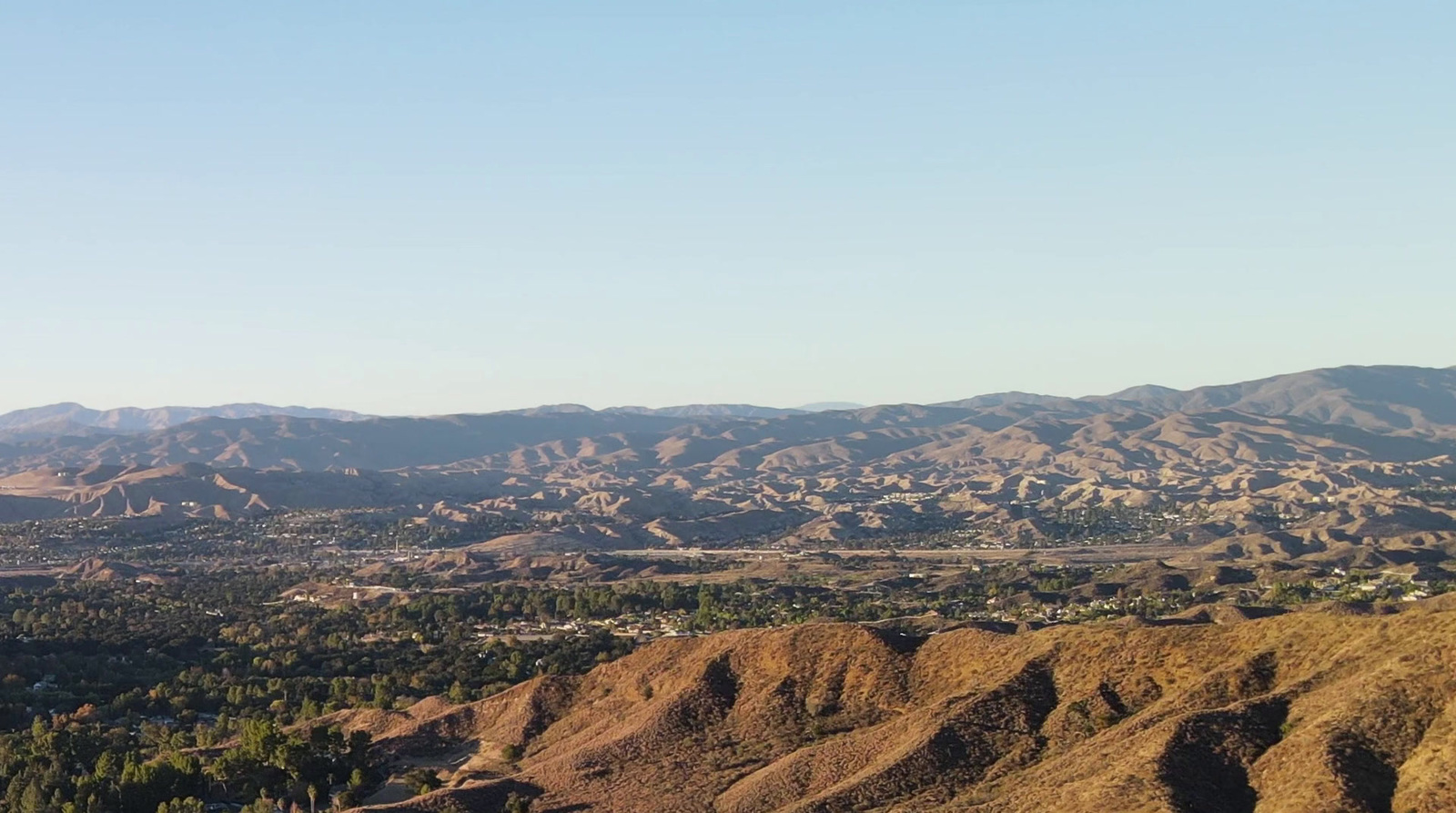 a view of the mountains from a hill top