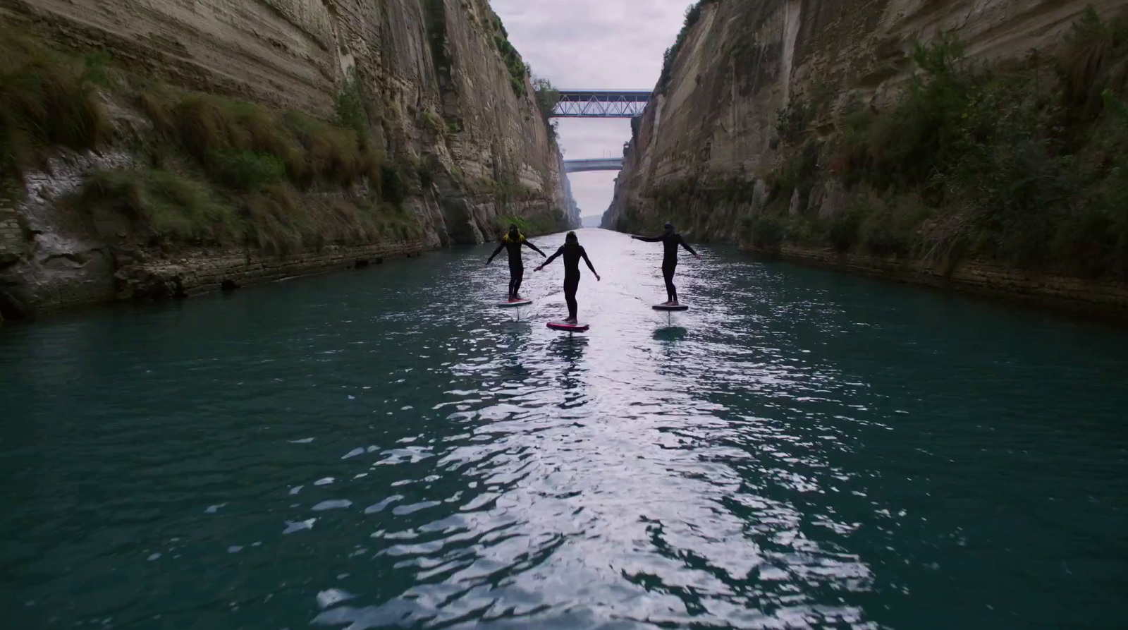 a couple of people riding paddle boards on a river