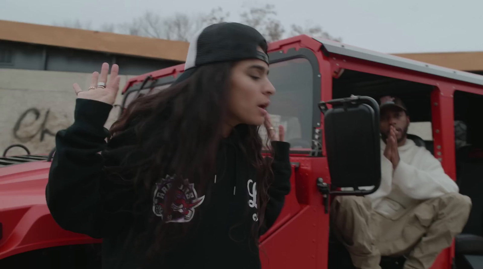 a woman sitting in the back of a red truck