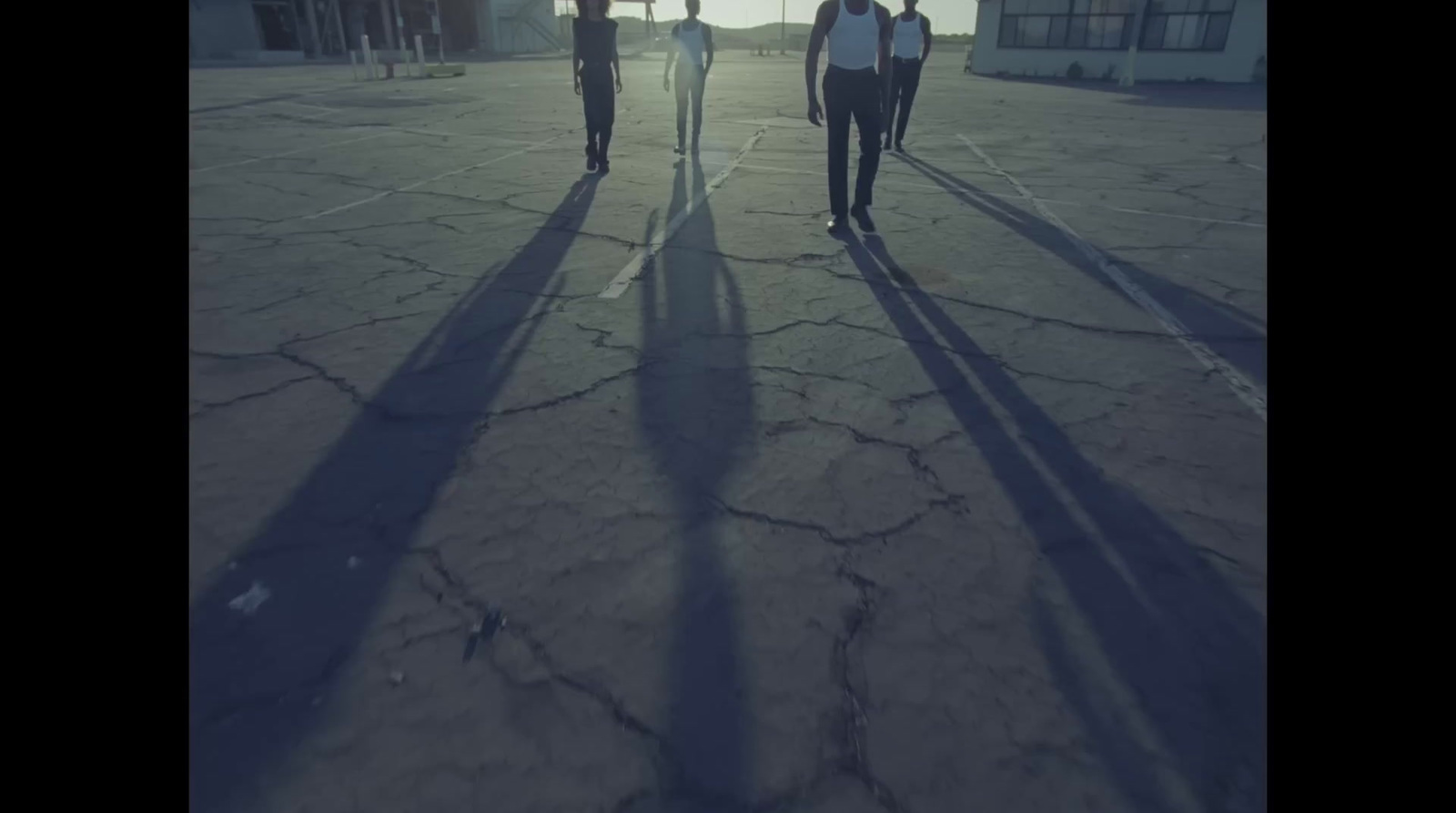 a group of people walking across a street