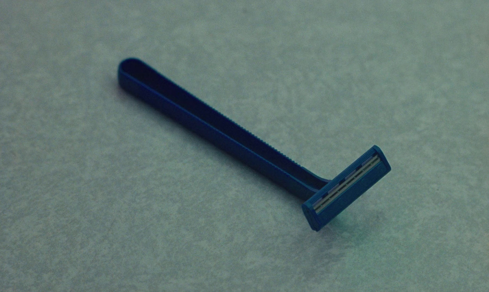 a close up of a blue toothbrush on a table