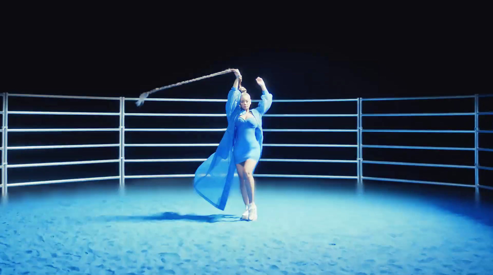 a woman in a blue dress is dancing