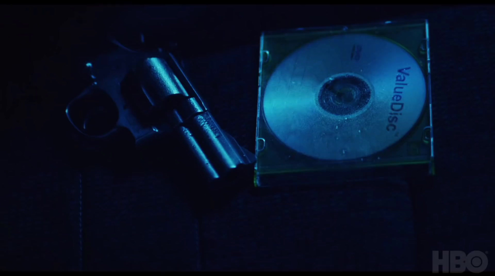 a dvd and a gun sitting on a table