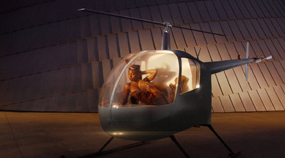 a helicopter with a woman in a bikini inside of it