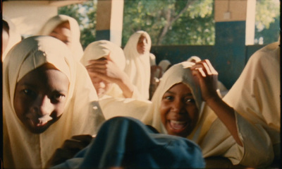 a group of women in white headscarves sitting next to each other