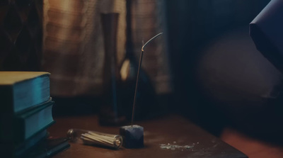 a table with books and a candle on it