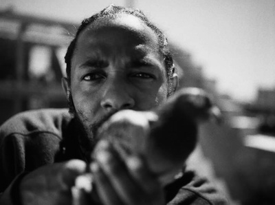 a black and white photo of a man pointing a gun