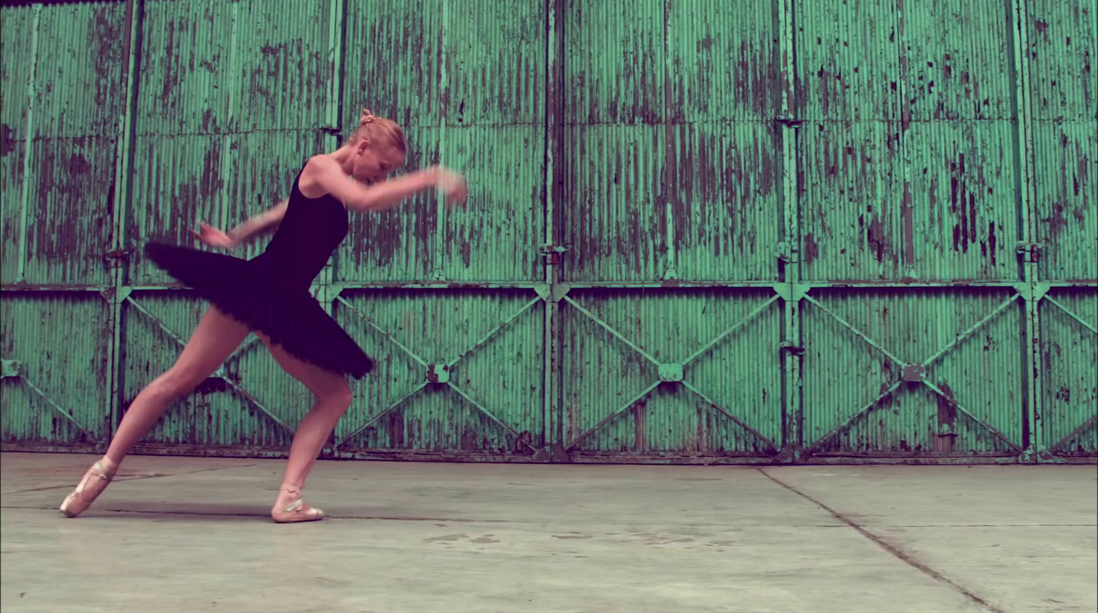 a woman in a black dress is dancing