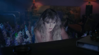 a woman sitting in front of a laptop computer