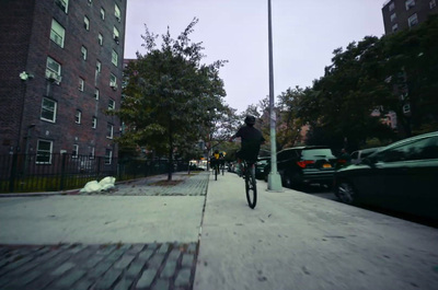 a person riding a bike down a sidewalk