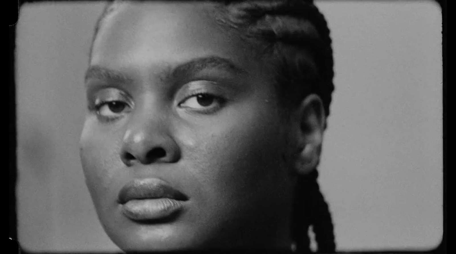 a black and white photo of a woman with braids