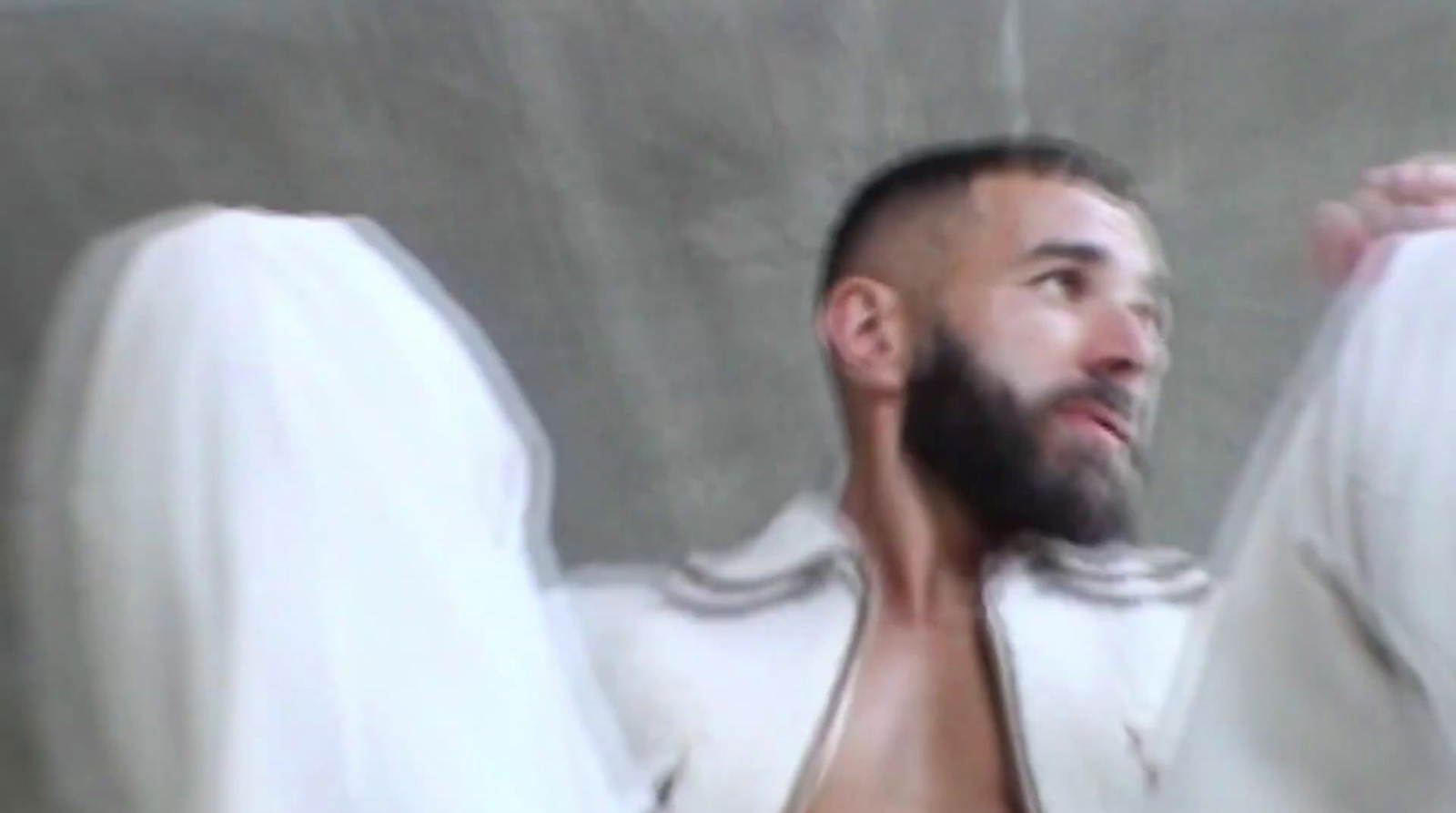 a man with a beard wearing a white robe