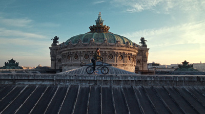 a man riding a bike on top of a roof