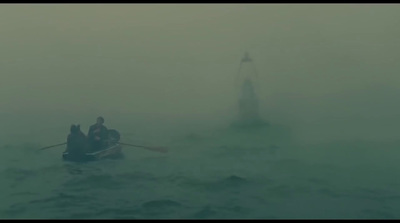 a man rowing a boat in a foggy sea