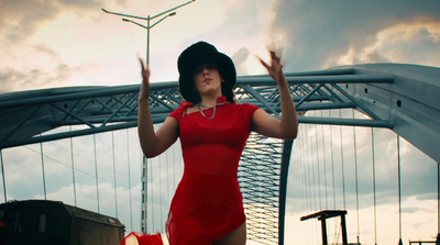 a woman in a red dress and black hat