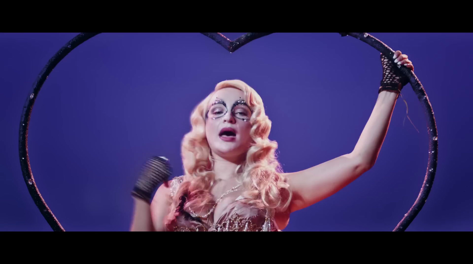 a woman holding a hair brush in front of a heart