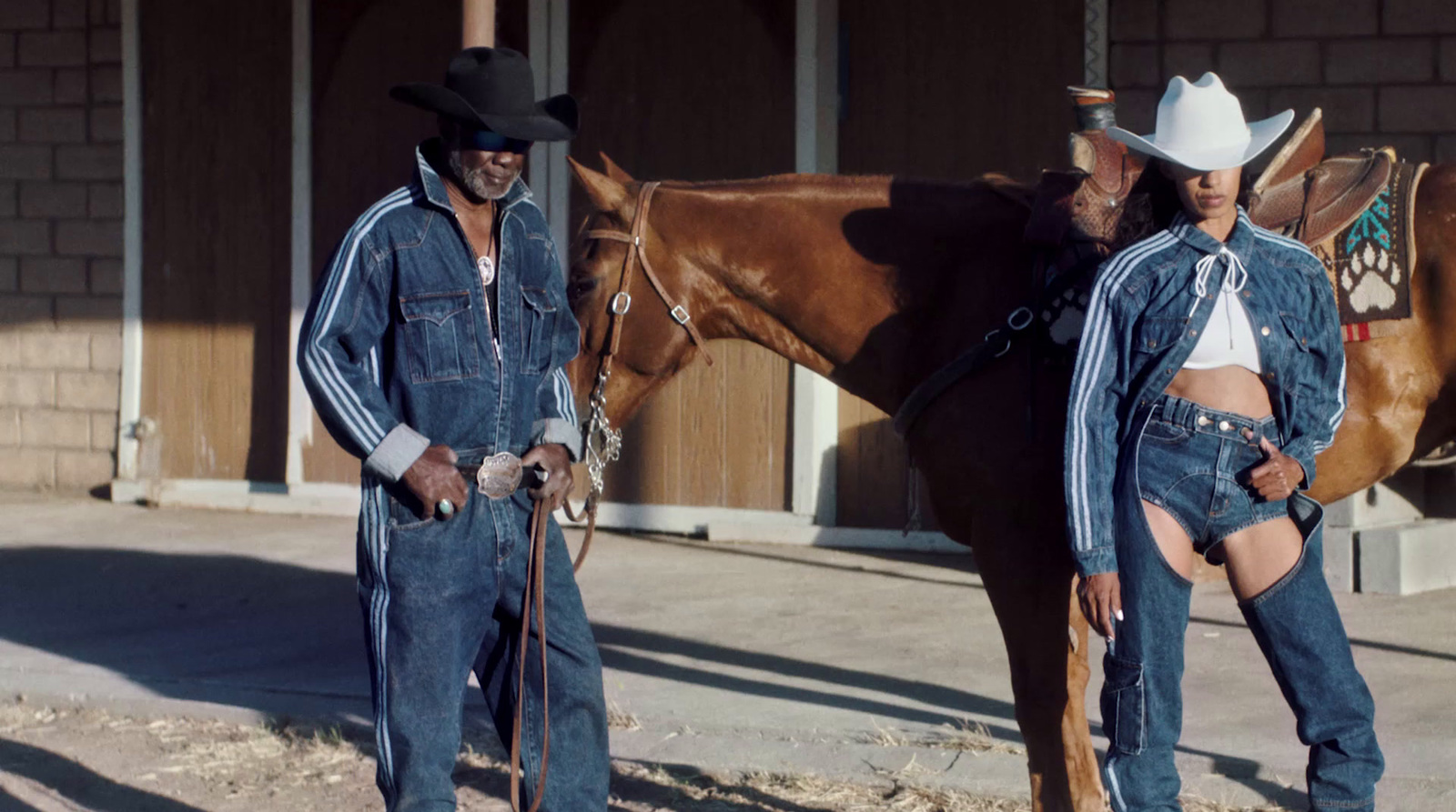 a man and a woman standing next to a horse