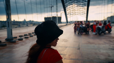 a group of people walking across a bridge