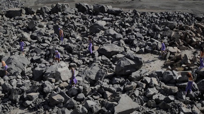 a group of people standing on top of a pile of rocks