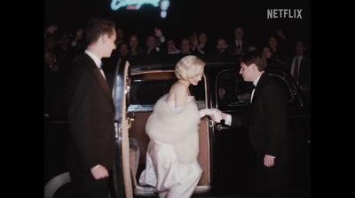 a woman in a white dress getting out of a car