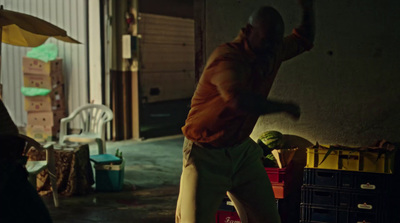 a man standing in a garage holding an umbrella