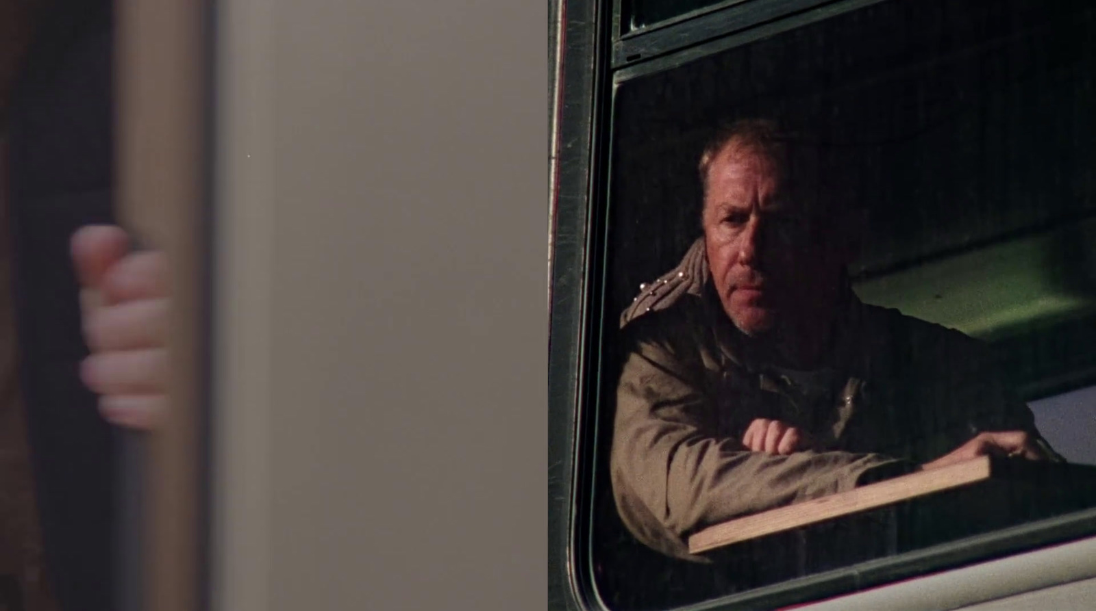 a man looking out the window of a bus