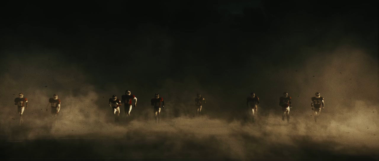 a group of people running in the dust