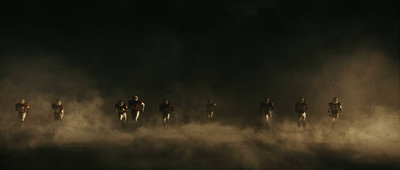 a group of people running in the dust