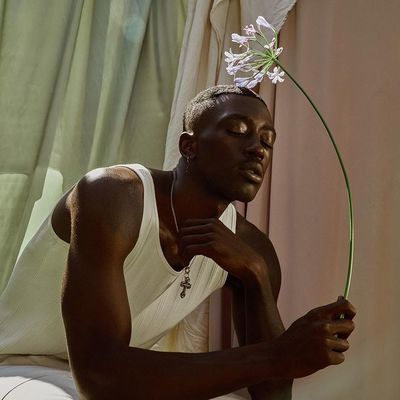 a man with a flower in his hair