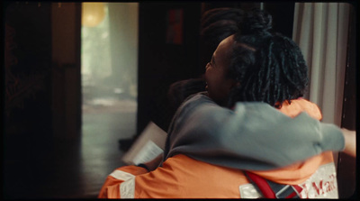 a woman with dreadlocks sitting in a chair