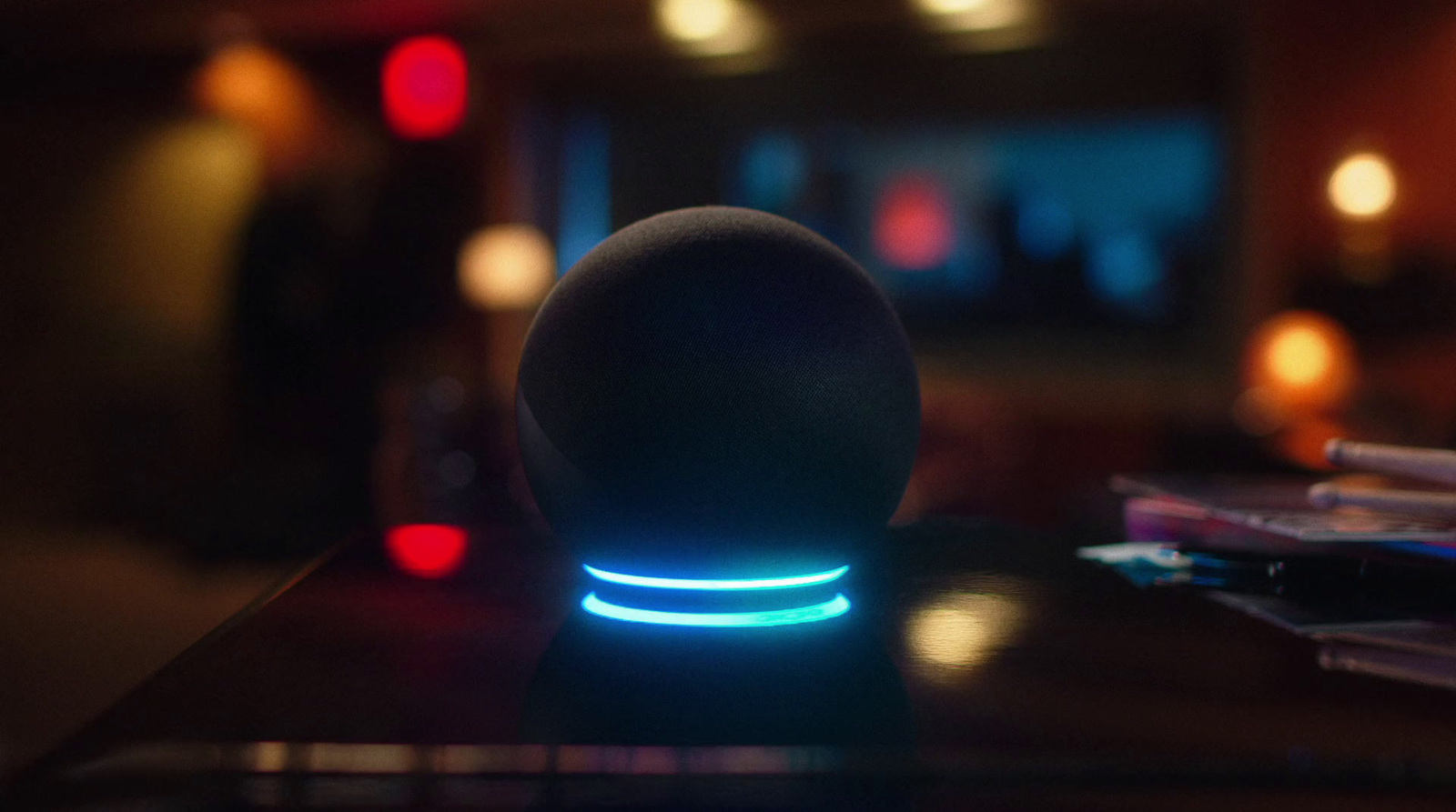 a black speaker sitting on top of a table