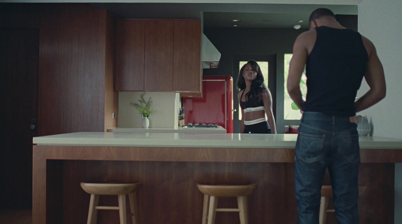 a man and a woman standing in a kitchen