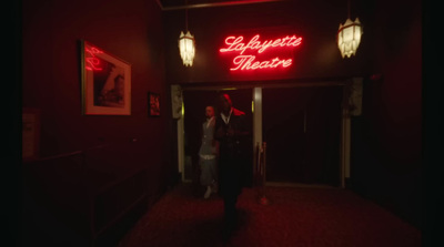 a man standing in the doorway of a theatre