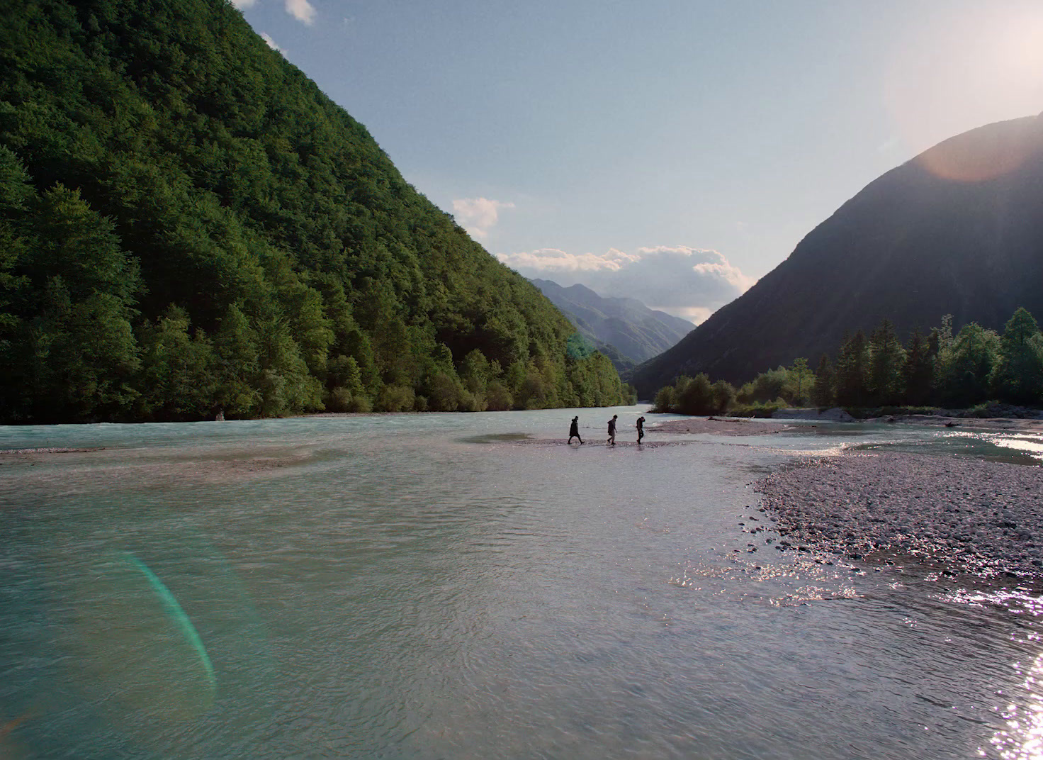 a group of people wading in a river