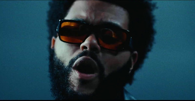 a man with a beard and sunglasses making a face