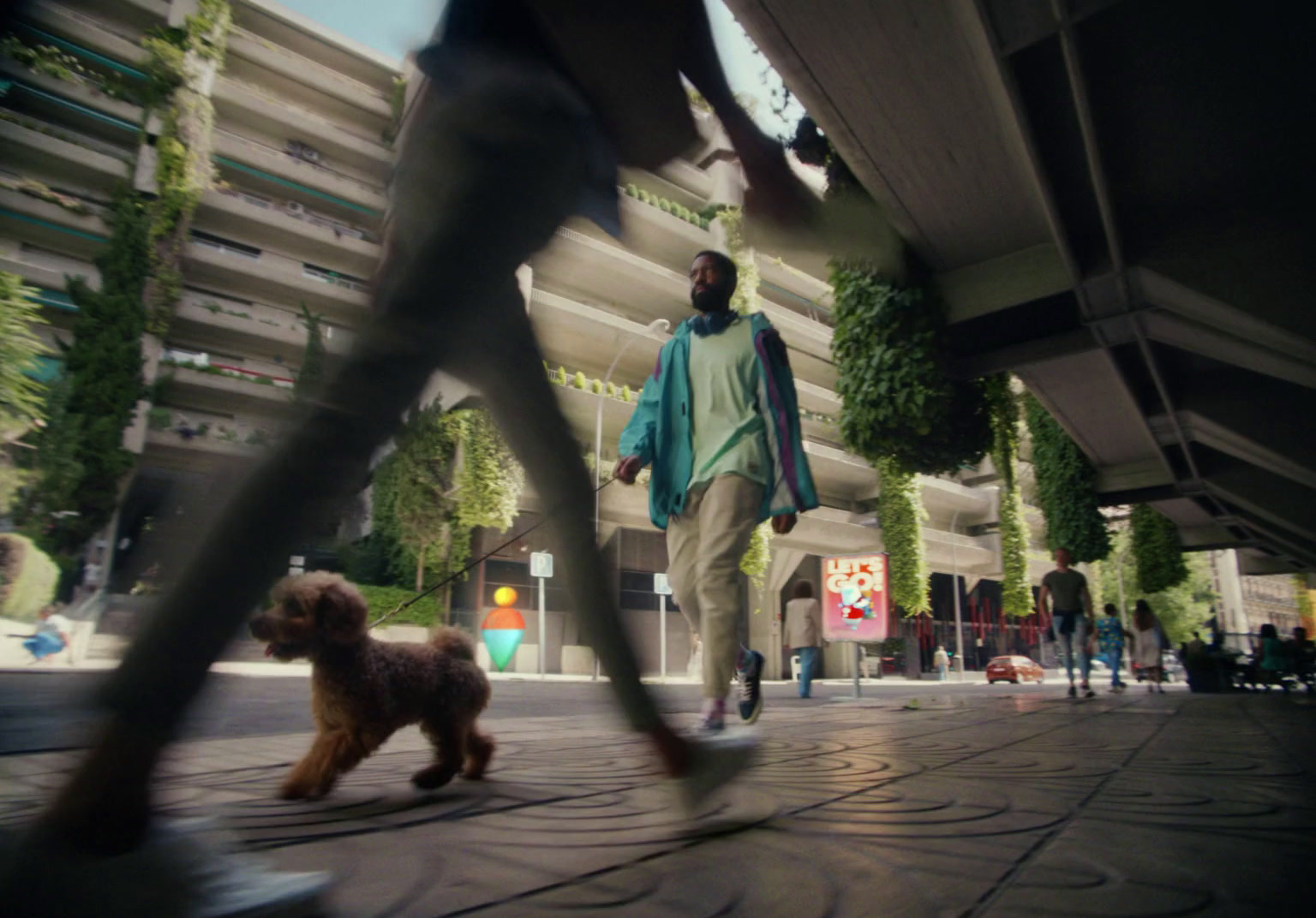 a man walking a dog on a city street