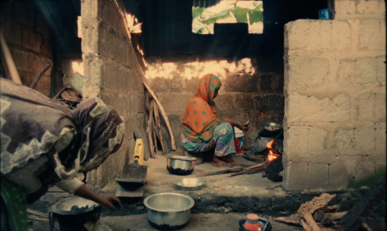 a woman sitting on the floor of a kitchen