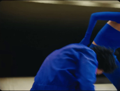 a woman in a blue outfit doing a handstand