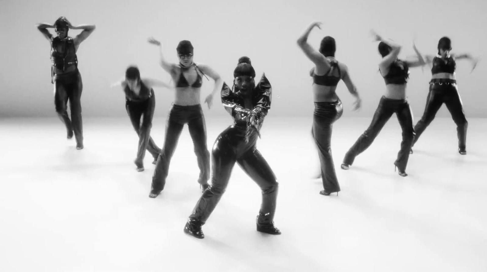 a group of women in black and white dancing