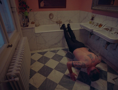 a man laying on the floor in a bathroom