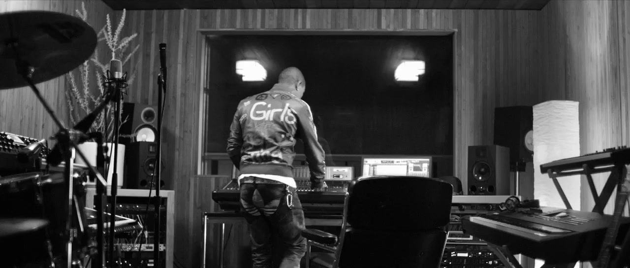 a man standing in front of a recording equipment